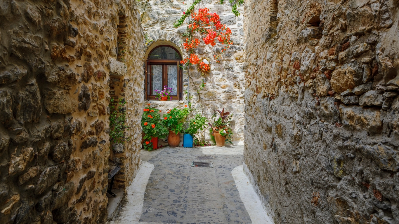 A small alley in Mesta village, Chios, featuring traditional stone-built houses and a cobblestone street, reflecting the village's medieval architecture and charm.
