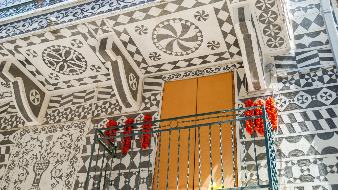 A traditional building in Pyrgi village, Chios, featuring intricate geometric patterns called "xysta" on its facade, showcasing the village's unique architectural style